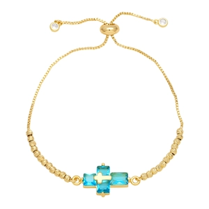 Detail of adjustable gold double layer cross bracelet with blue sapphire-like stones