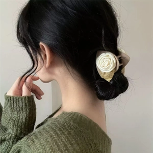 Elegant cream camellia flower hair claw clip with golden leaves on woman hairstyle