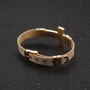 Detail of golden stainless steel mesh bracelet with cross charm and adjustable buckle