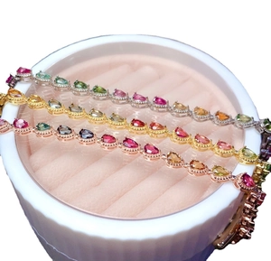 Set of three colorful teardrop gemstone bracelets in silver, gold, and rose gold plating