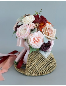 Detail of bridal bouquet with roses and peonies, featuring elegant silk ribbon handles