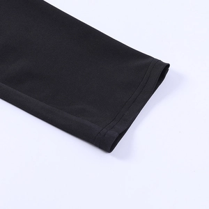 Close-up of black tight jumpsuit sleeve cuff showing double-needle stitching details