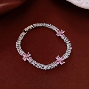 Elegant silver bracelet with white zircons and pink heart-shaped cherry blossoms
