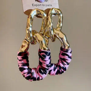 Chic oval earrings with gold irregular metal ring and pink leopard fabric wrapping