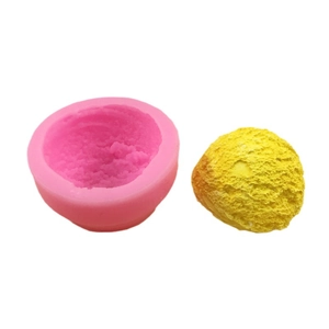 Pink silicone ice cream mousse mold with textured hemispherical sphere on white background