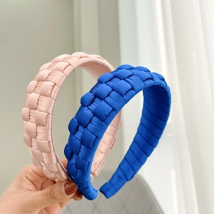 Detail of pink and royal blue braided satin headbands with thick padded texture