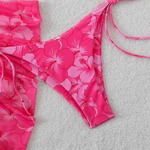 Detail of pink hibiscus floral print and adjustable tie strings on a bikini set