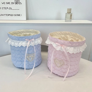 Detailed view of quilted cotton desk organizers with lace trim and heart embroidery