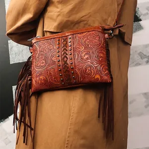 Bohemian brown embossed leather fringe crossbody bag with floral pattern and tassels