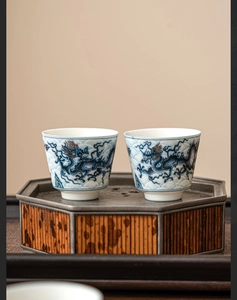 Macro detail of high-grade blue and gold dragon pattern on ceramic tea cups