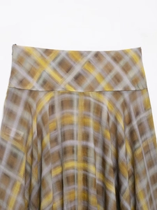 Detail of high-waist plaid midi skirt in yellow and grey semi-sheer fabric texture