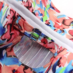 Macro shot of abstract floral print fabric with metallic silver buckle and clear straps