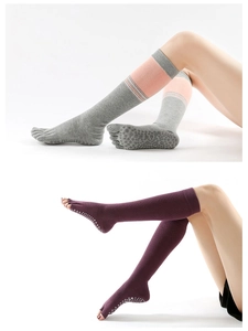 Detail showing non-slip silicone grippers on long cotton yoga five-finger socks