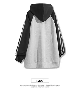 Rear view of a loose fit hoodie featuring gray body with black sleeves and stripe details