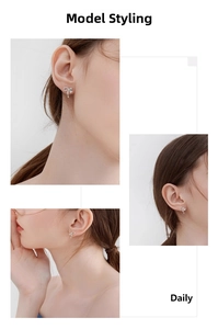 Close-up of silver bow earrings with micro-set stones and small round pendants