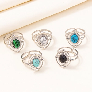 Detail view of five vintage adjustable rings with colorful oval stones and beaded edges