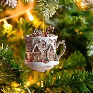3D gingerbread house coffee mug ornament hanging on a festive Christmas tree