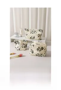Detail of floral embroidery and diamond quilting on linen cotton cosmetic bag set