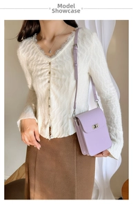 Detailed view of light purple mini crossbody bag on model with silver metal twist lock