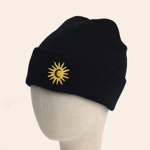 Thick knit black beanie with yellow sun and moon embroidery in minimalist street style