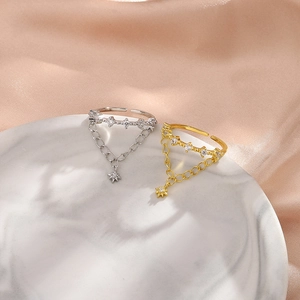 Macro shot of double layer silver and gold chain rings with star zircon pendants