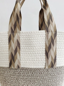 Bohemian woven cotton rope beach bag with beige textures and patterned shoulder straps
