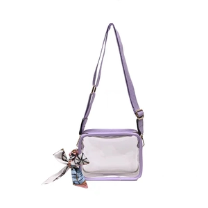Detail view of transparent PVC crossbody bag with purple trim and floral scarf