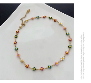 Detail of colorful daisy pendant necklace with gold chain and lobster clasp closure