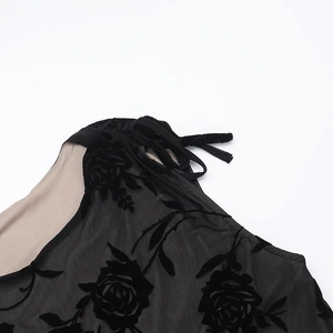 Detail of black flocked rose pattern on sheer mesh fabric with shoulder tie straps