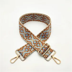 Ethnic style woven shoulder strap with geometric patterns and golden metal hardware