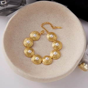 Macro shot of gold spiral textured pearl bracelet in 18K stainless steel elegantly displayed