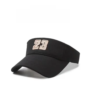 Detail of black visor hat with white embroidered number 23 and woven texture fabric