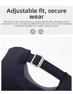 Detail of adjustable metal buckle and stitching on dark blue cotton baseball cap