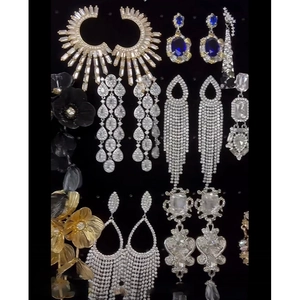 Exaggerated floral crystal earrings set in gold, silver and black finishes for parties