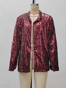Detail shot of wine red sequin blazer featuring lapel collar and shimmering texture