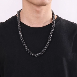 Detailed close-up of a vintage black skull pendant necklace worn on a fashion model