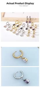 Detail of tear-drop zircon pendants and hoop closure on gold-plated stainless steel earrings