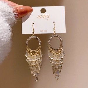 Détail des boucles d'oreilles à pampilles en cristal doré avec tiges en argent S925