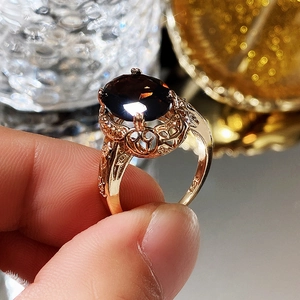 Detail view of vintage S925 silver ring with red zircon and ornate hollow engraving