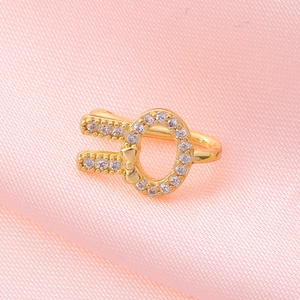 Close-up of golden U-shaped non-piercing nose ring with micro-set zircon butterfly motif