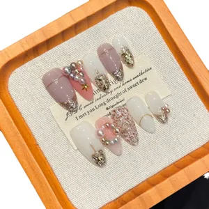 Handmade Christmas press-on nail set with 3D stars, pearls, and pink glitter gradient