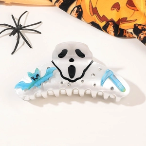 Detail showing acrylic Halloween hair claw with Ghostface, bat and sickle elements