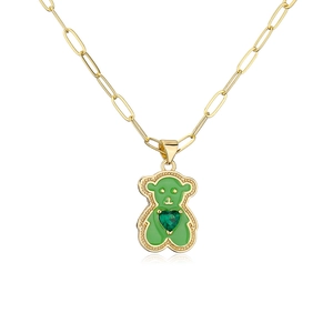 Detail of green enamel bear pendant with heart zircon on gold paperclip chain necklace