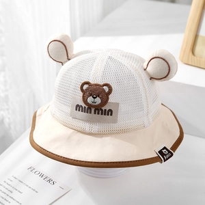 Macro detail of breathable mesh baby sun hat with cute bear patch and soft chin strap