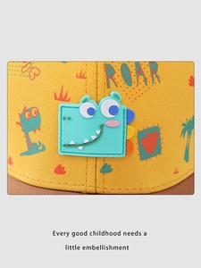 Detail of yellow kids baseball cap featuring 3D blue dinosaur and ROAR embroidery