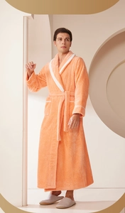 Detail of coral orange waffle texture bathrobe with white contrast trim and waist tie