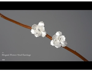 Macro shot of 925 sterling silver begonia flower earrings with a frosted matte finish