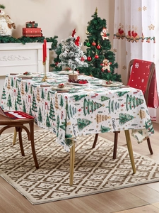 Close-up of polyester Christmas tablecloth with festive tree prints and holiday textures