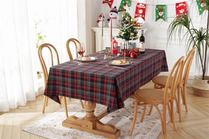 Detailed texture of red and green plaid Christmas tablecloth with festive decorations