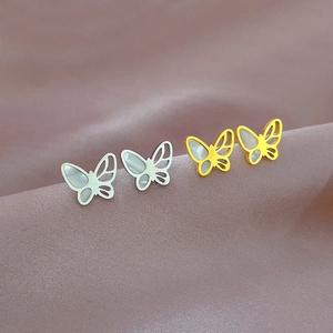Minimalist titanium steel butterfly stud earrings with mother of pearl on satin fabric